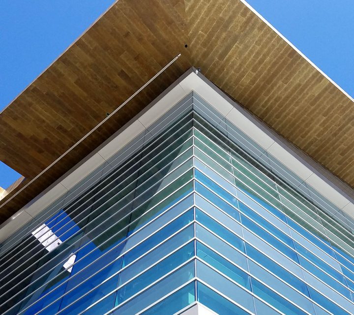 A view of the southwest corner of Fiserv Forum in Milwaukee shows the fritting on some window panes, giving the glass a frosty look. Fritted glass is visible to birds and reduces the danger of collisions. Photo courtesy of Populous.